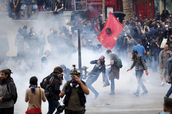 Tear gas fills the air as demonstrators clash with French riot police during a march near the Place de la Republique square in Paris, France, to demonstrate against the new French labour law, September 15, 2016. REUTERS/Charles Platiau